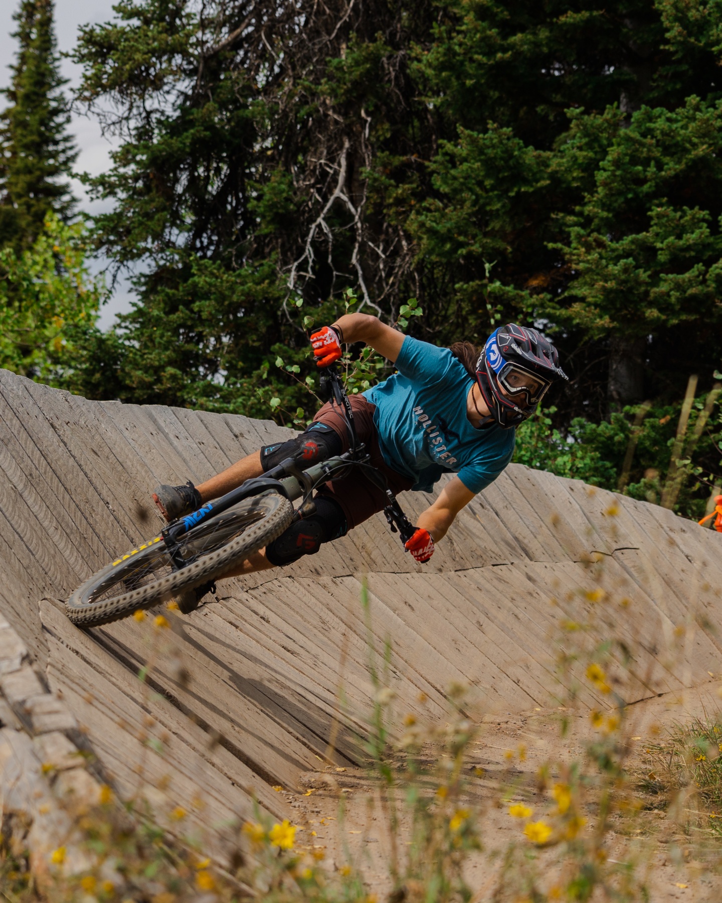 A mountain biker rides a berm