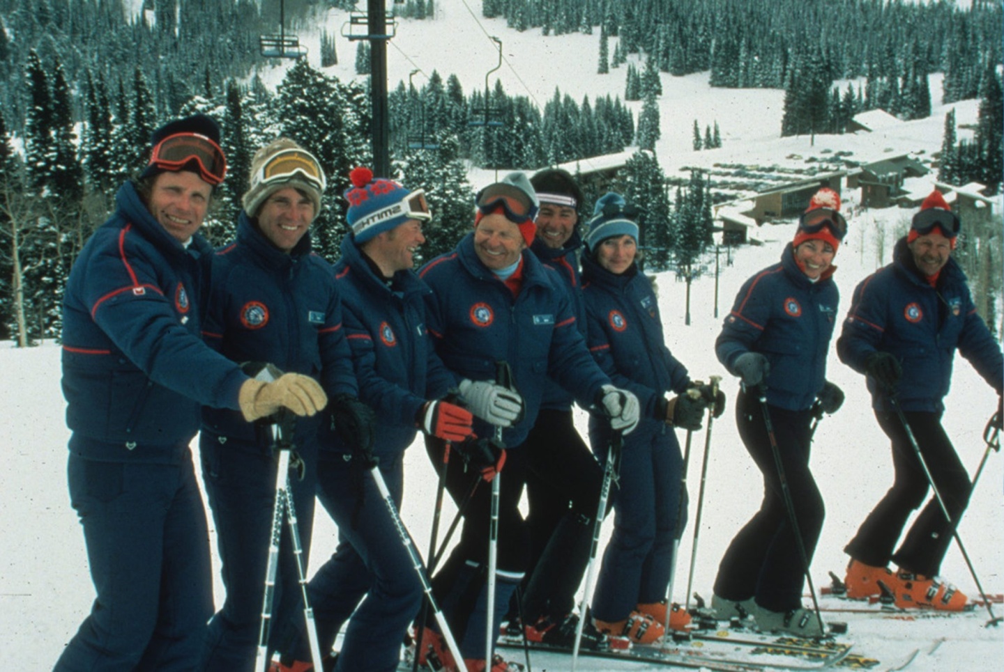 A group of skiers pose for a photo