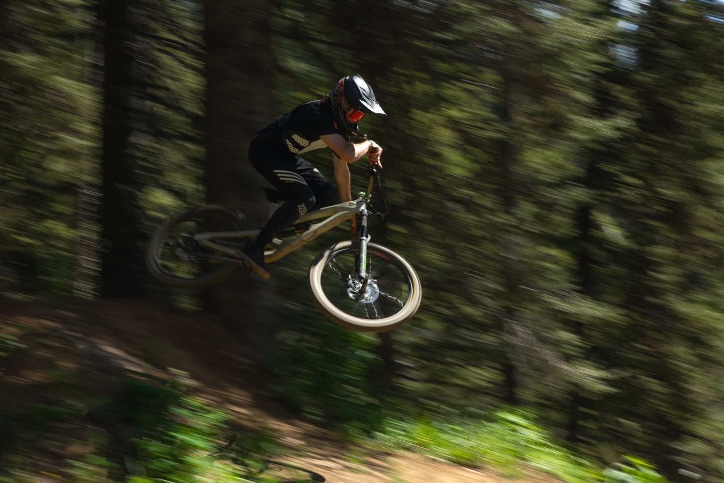 A mountain biker riding a jump