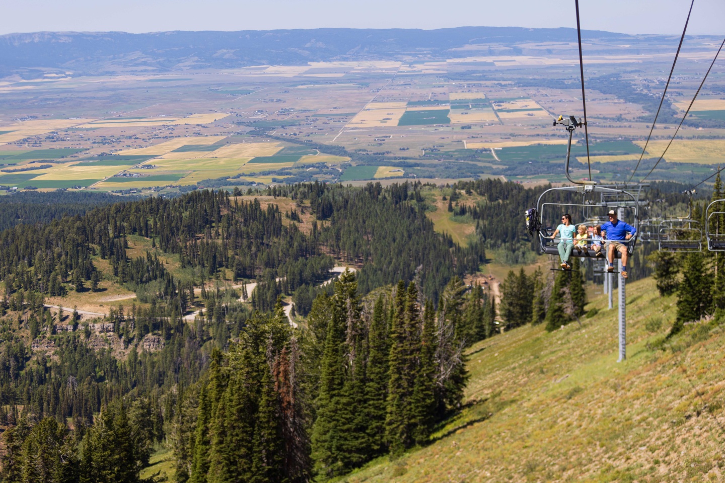 A family on a chairlift in summer