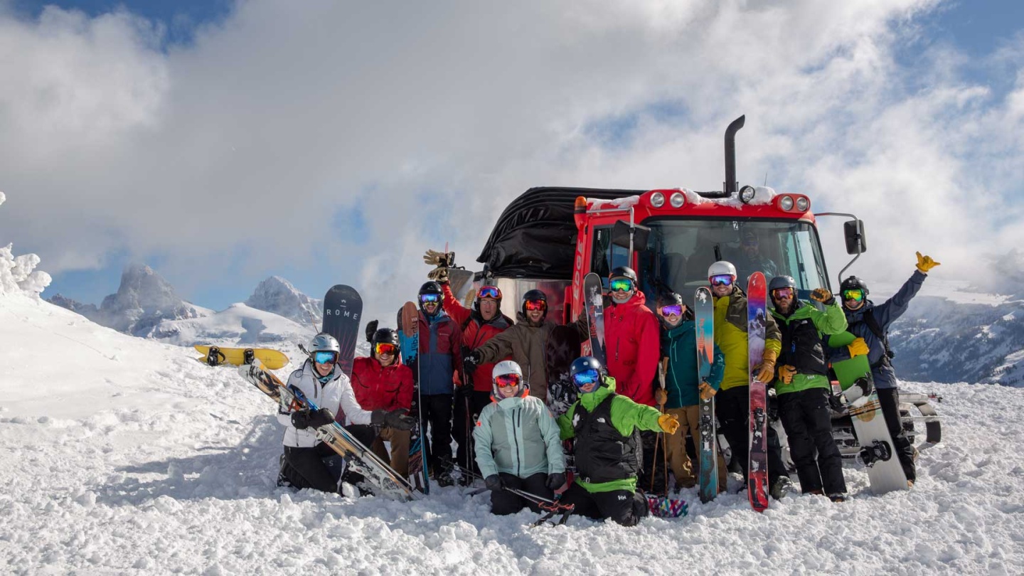 A group of cat skiers pose for a photo
