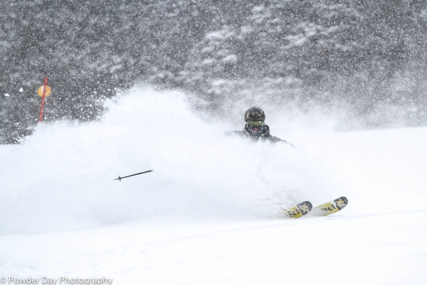 A skier riding through powder