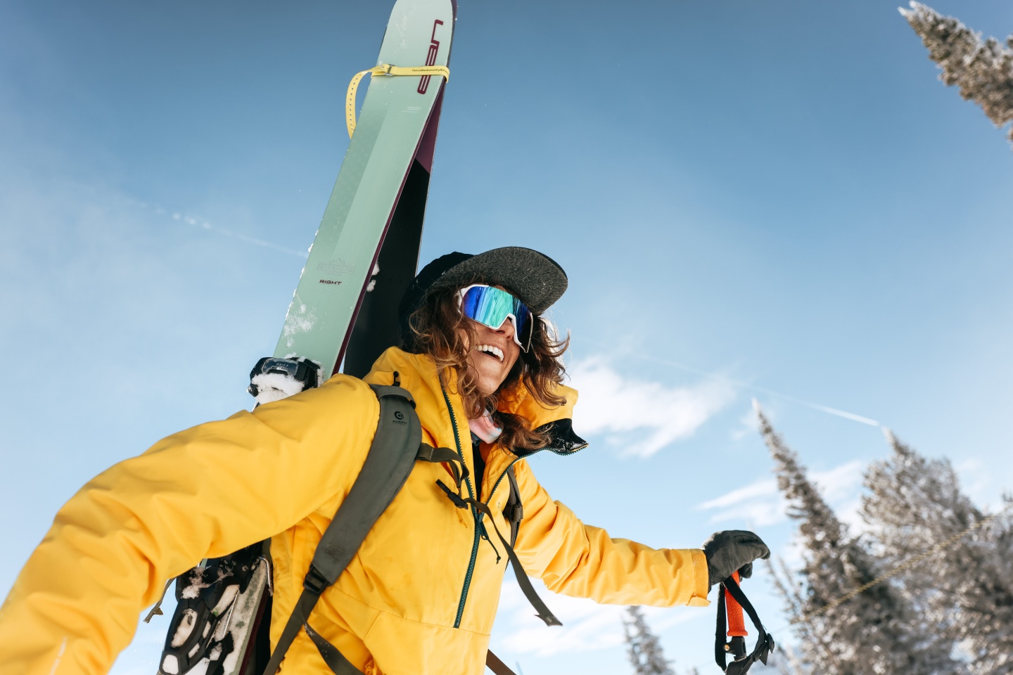 A woman boot packs up a snowy mountain