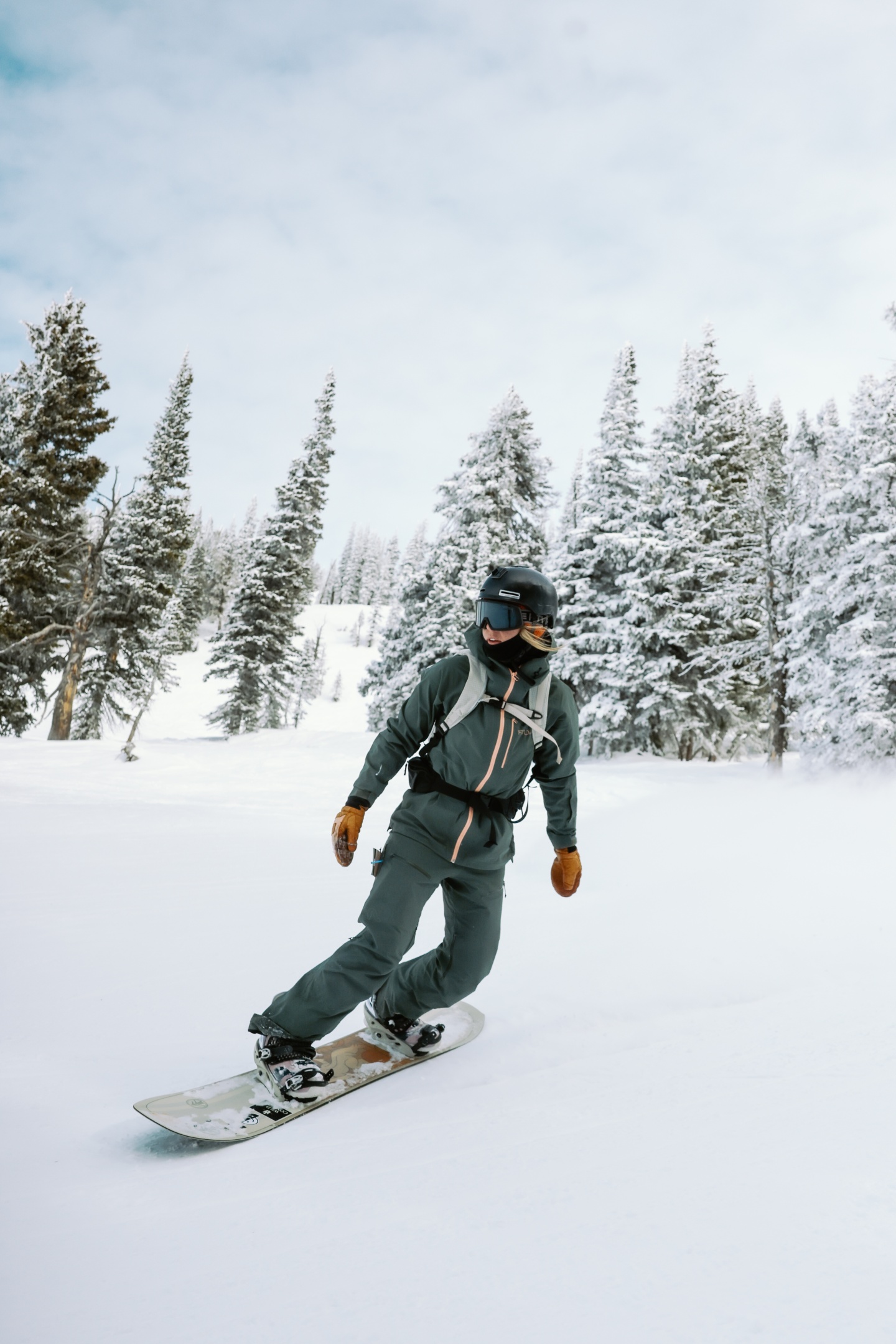 A snowboarder riding down a mountain