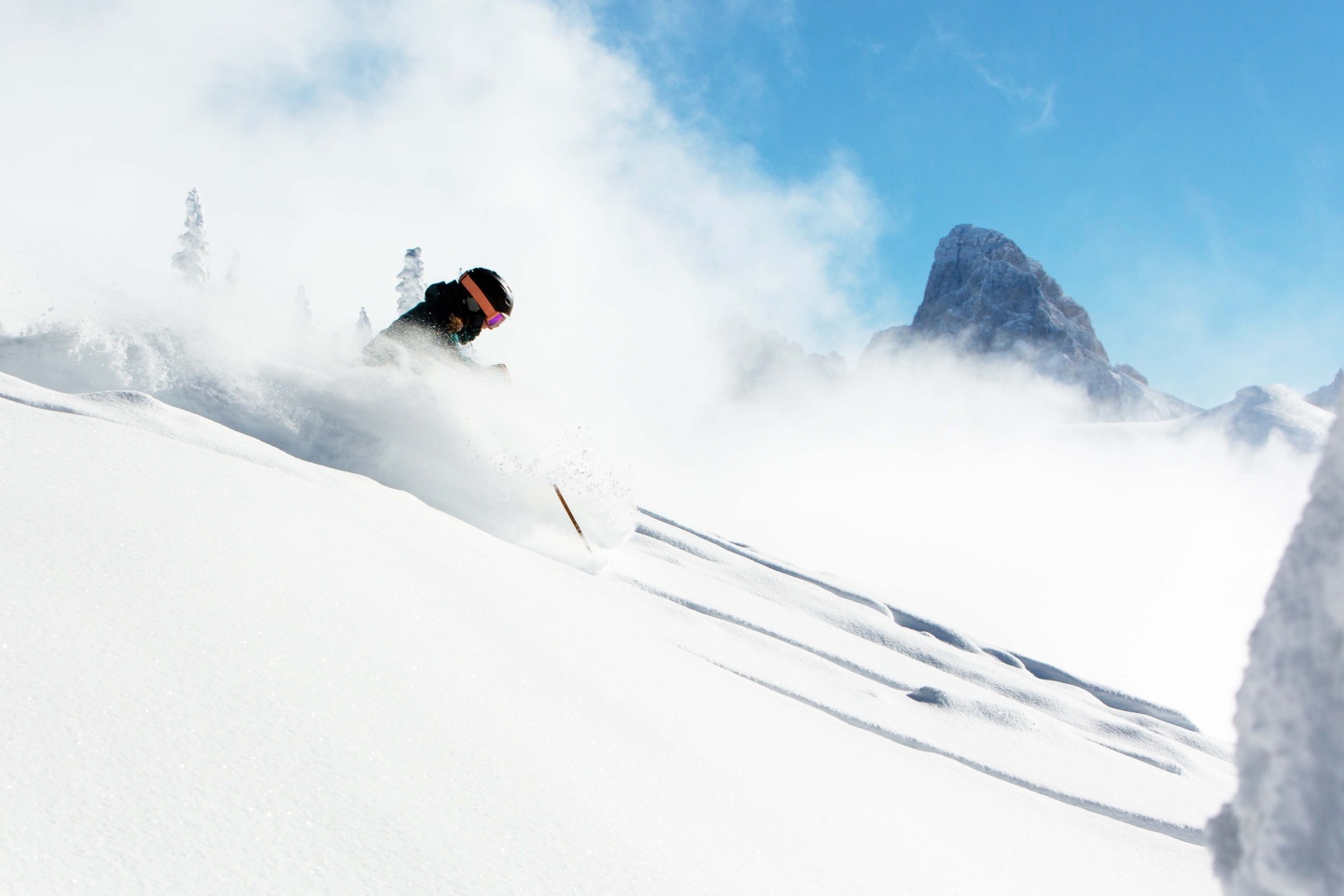 A skier skiing through powder snow