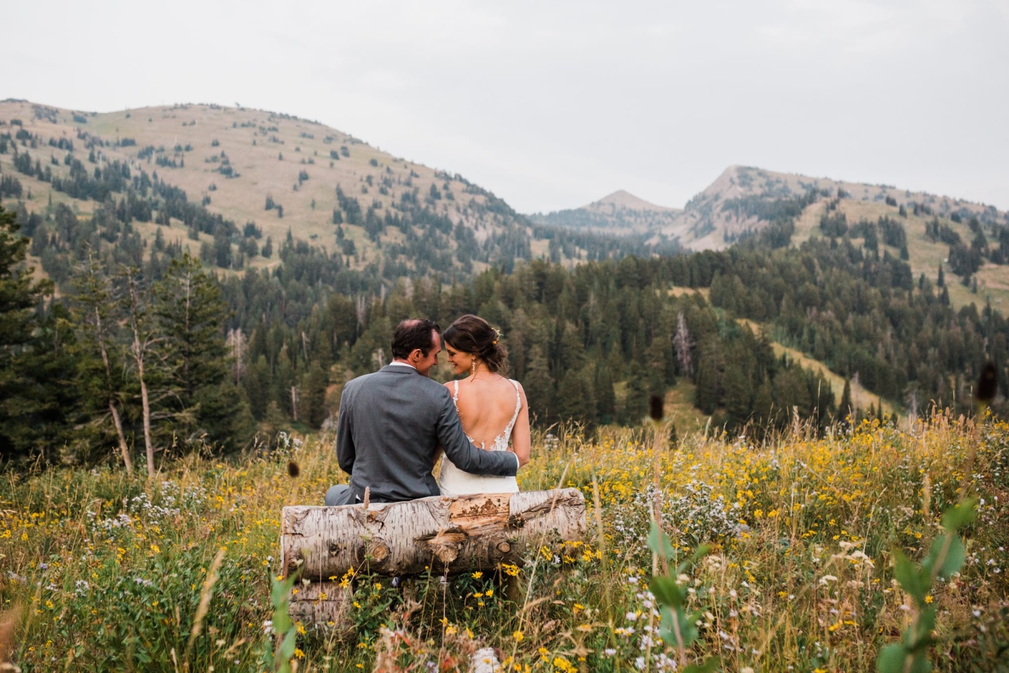 Couple on a bench looking at mountains