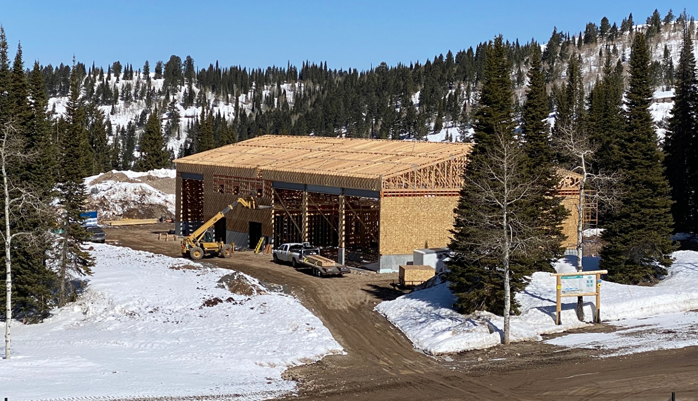 A large building on a ski hill, mid construction