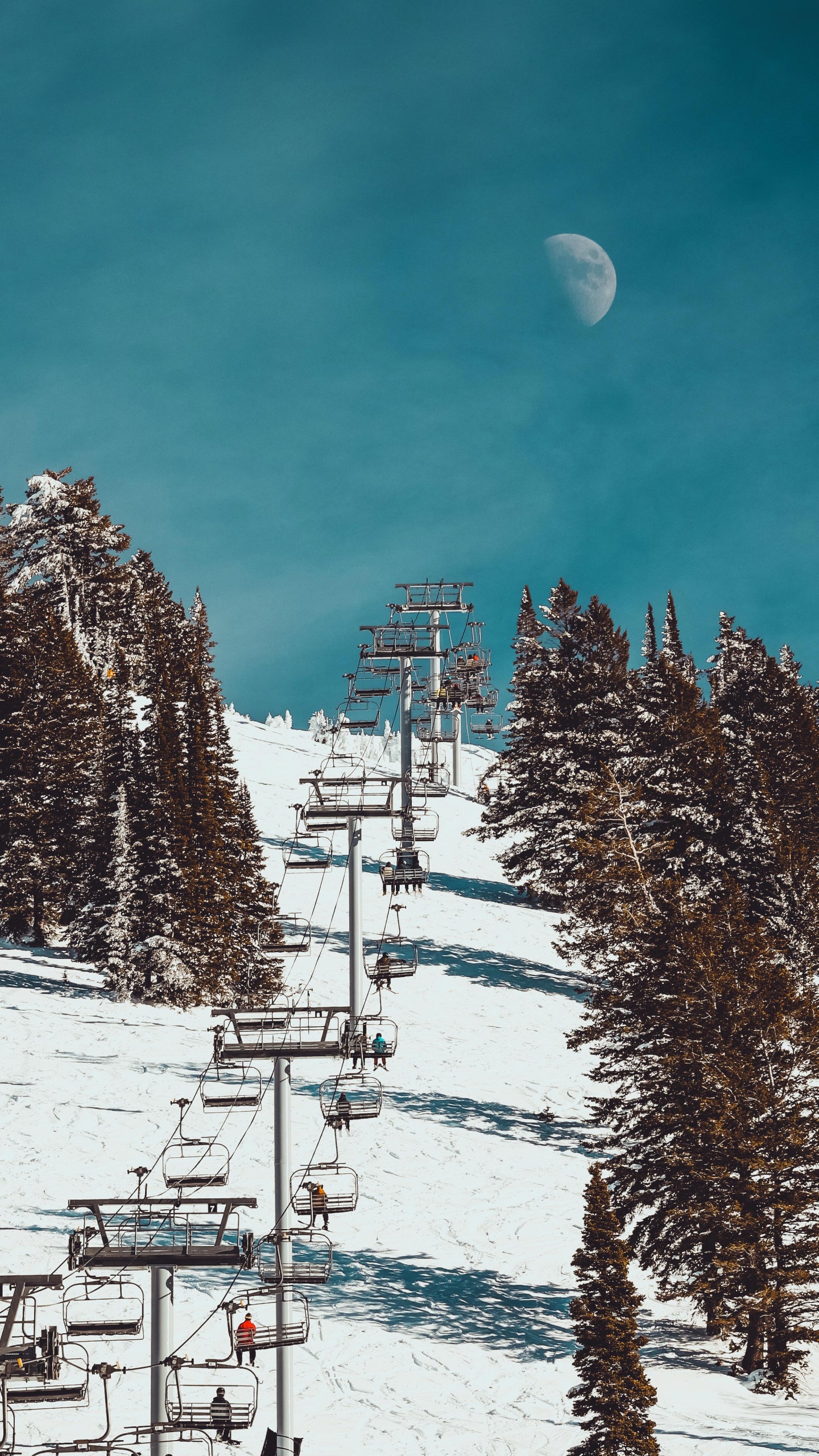A chairlift with a moon in the sky