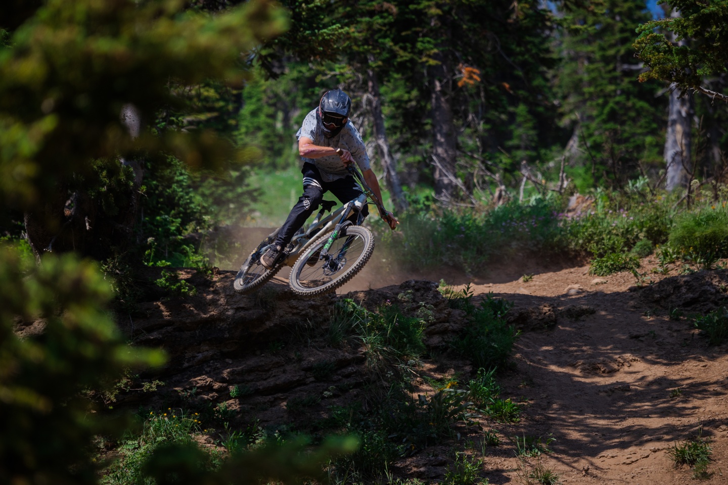 A downhill biker riding down a trail