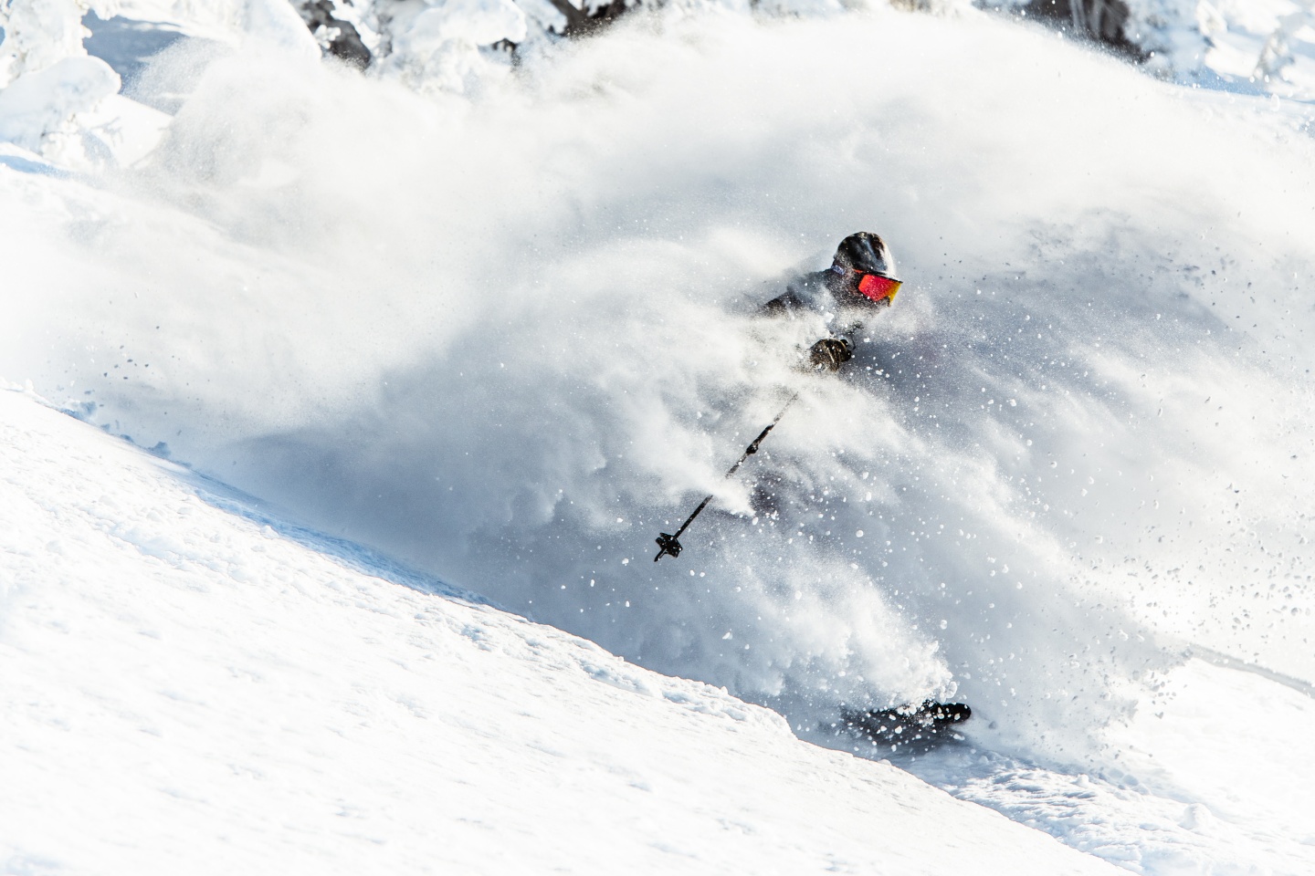 A skier riding through powder