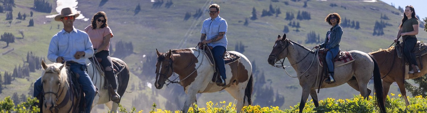 A group of adults horseback riding