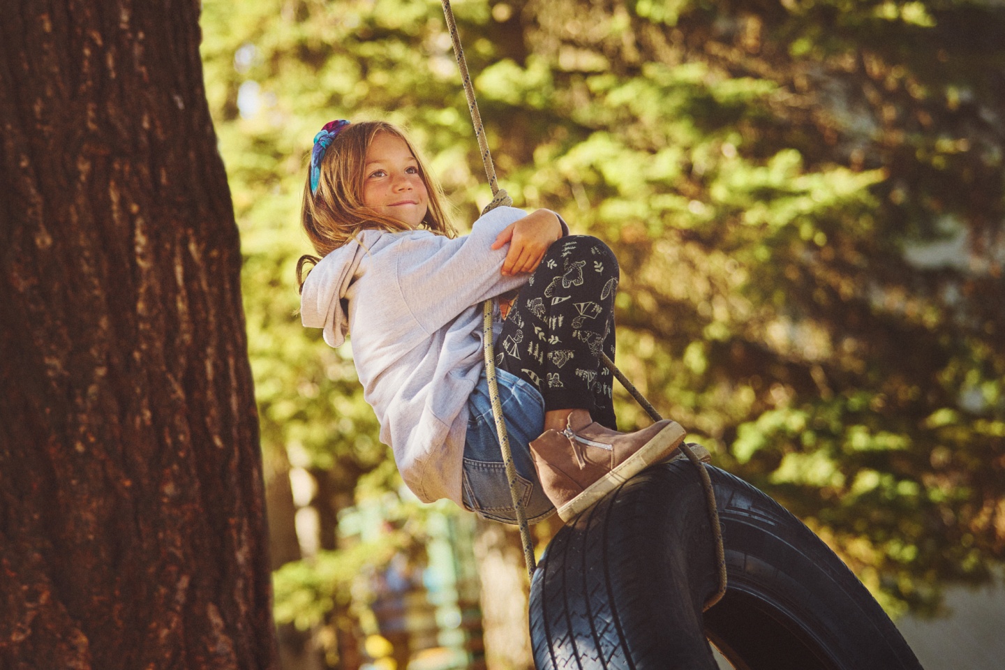 A child on a tire swing
