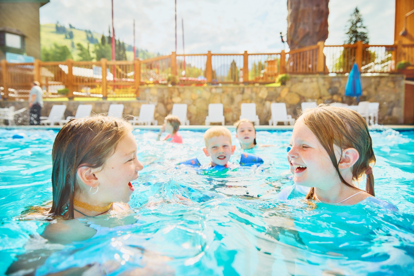 A group of kids chatting in a pool