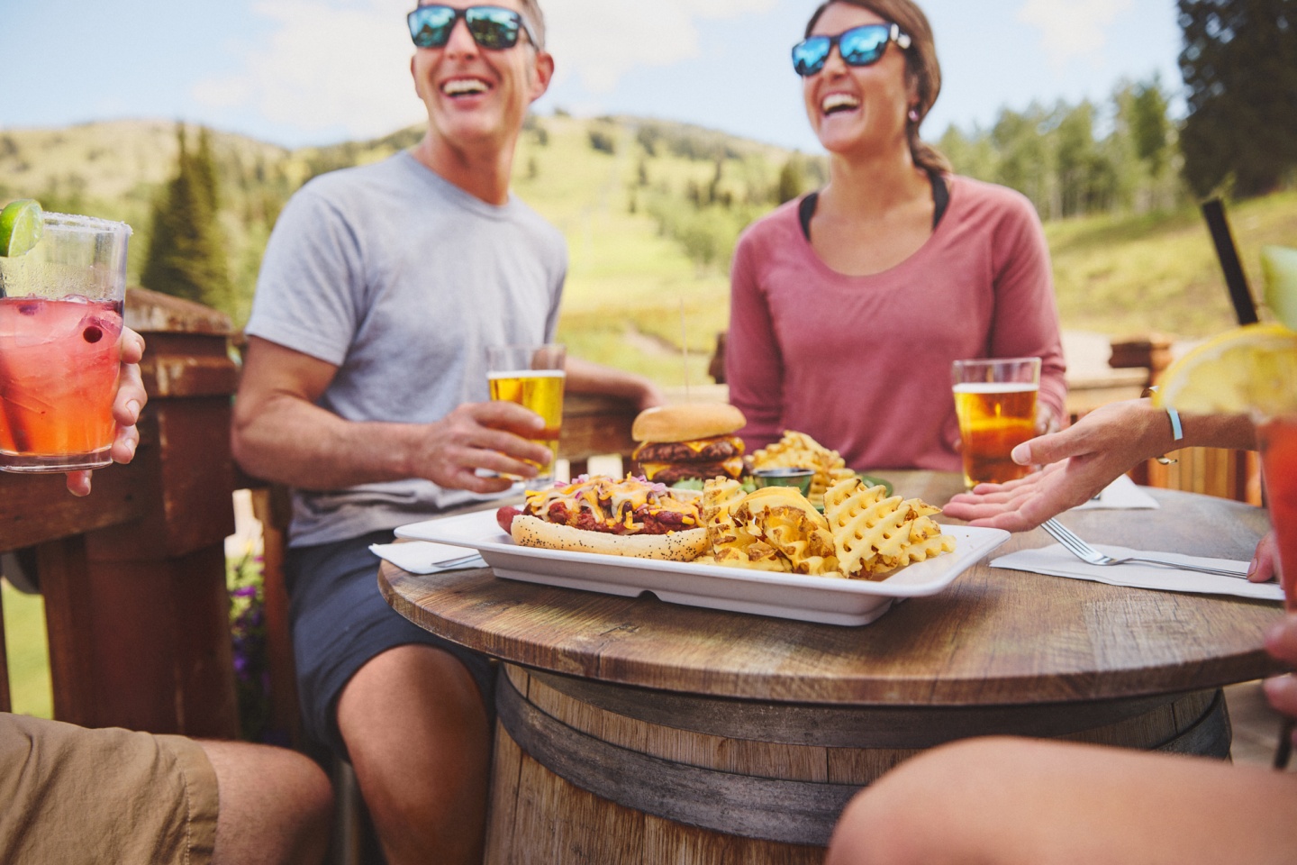 A group of friends enjoying food on a patio