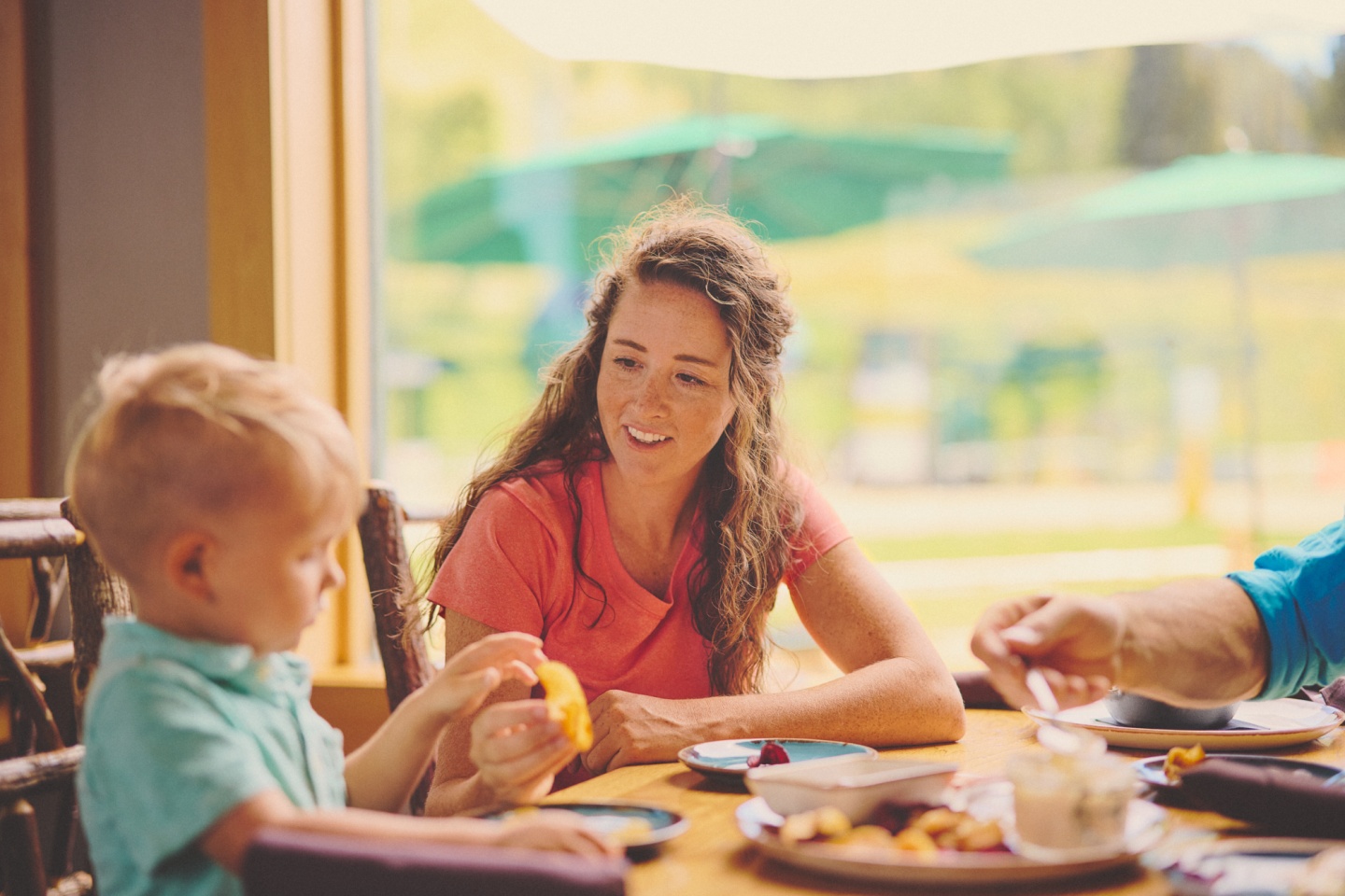 A mother and son enjoying lunch in a restaurant