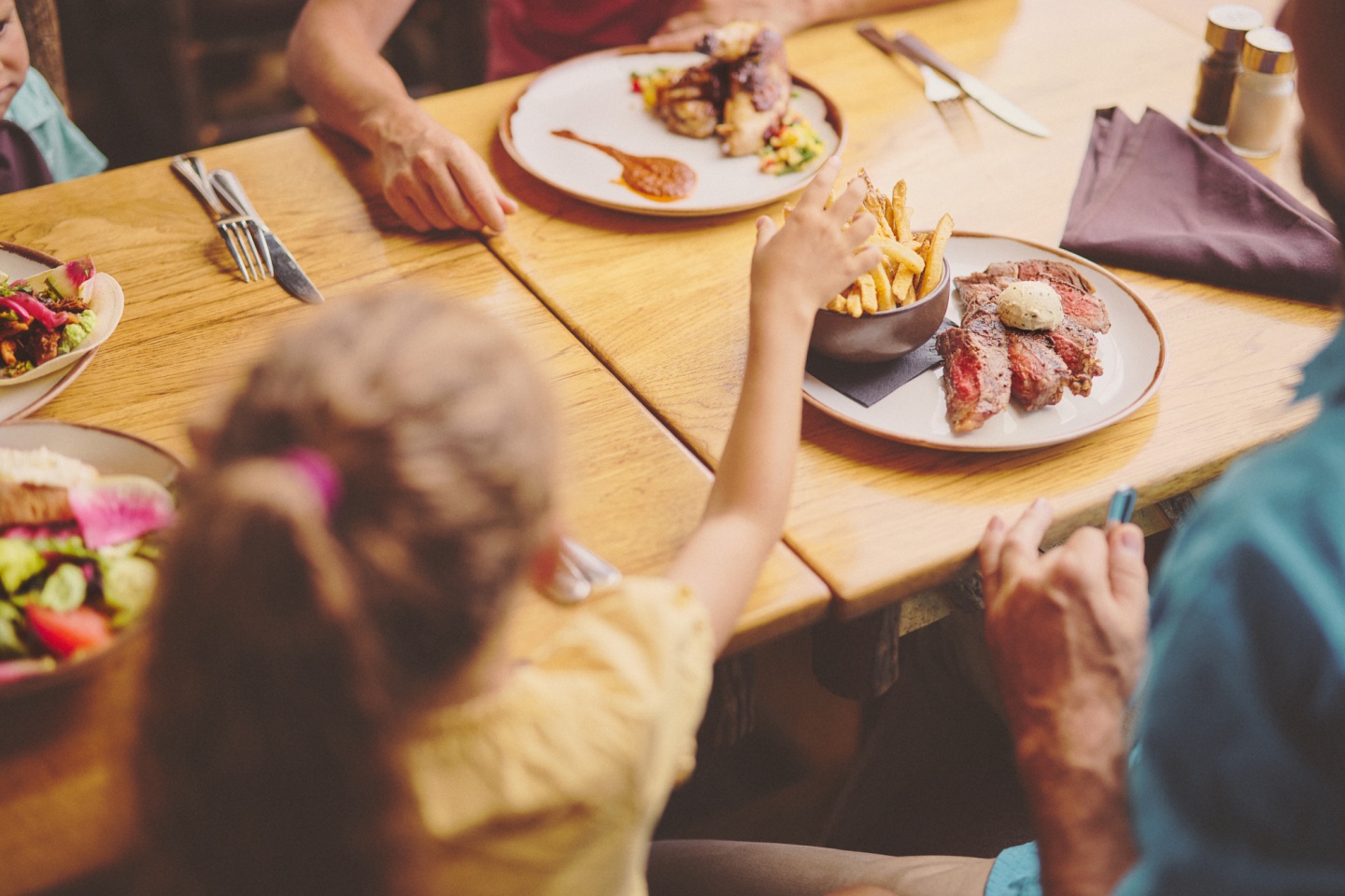 A family of four enjoying lunch in a restaurant