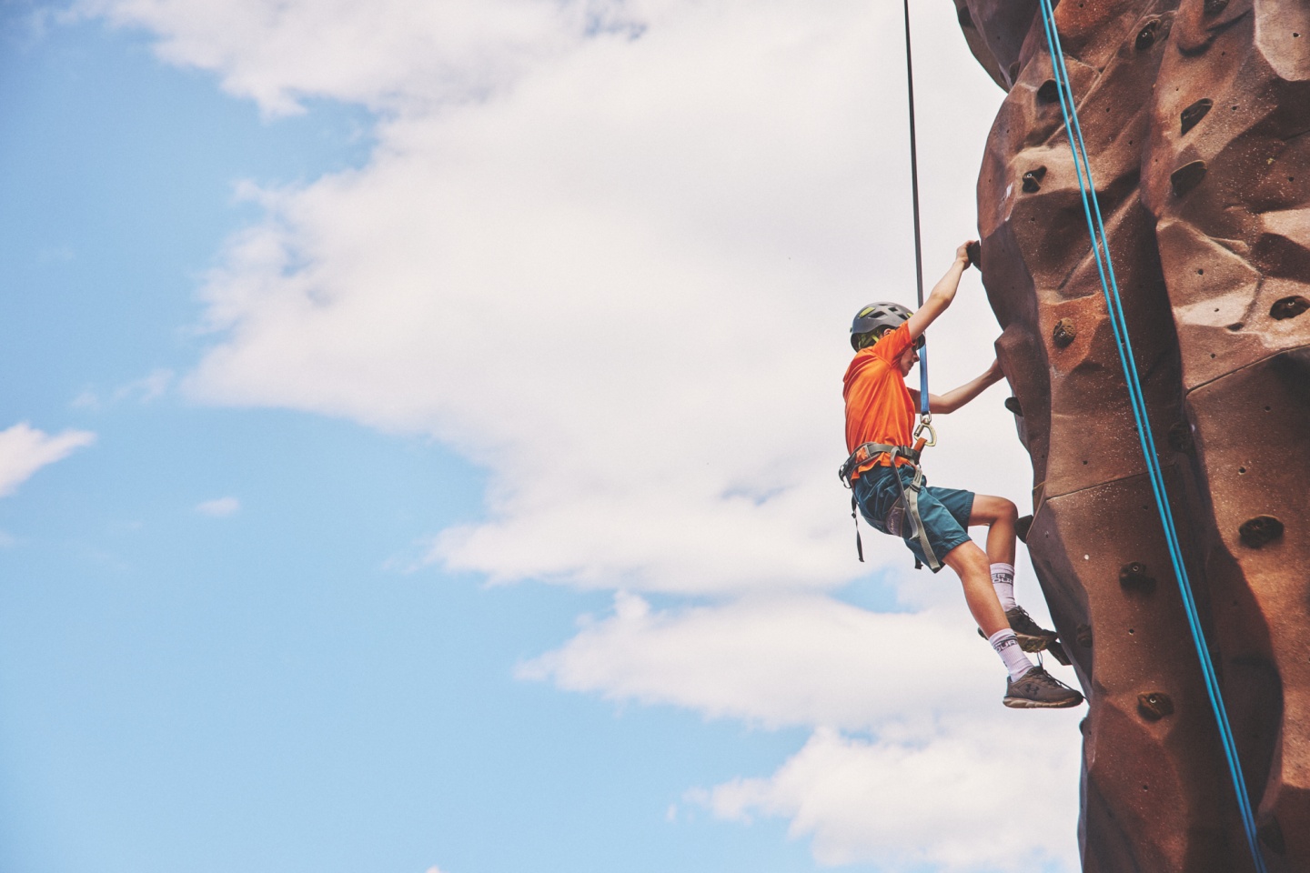 A child using a climbing wall