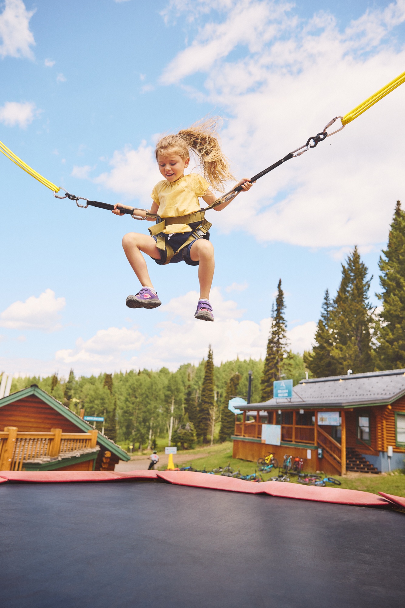 A child bounding on a bungee trampoline