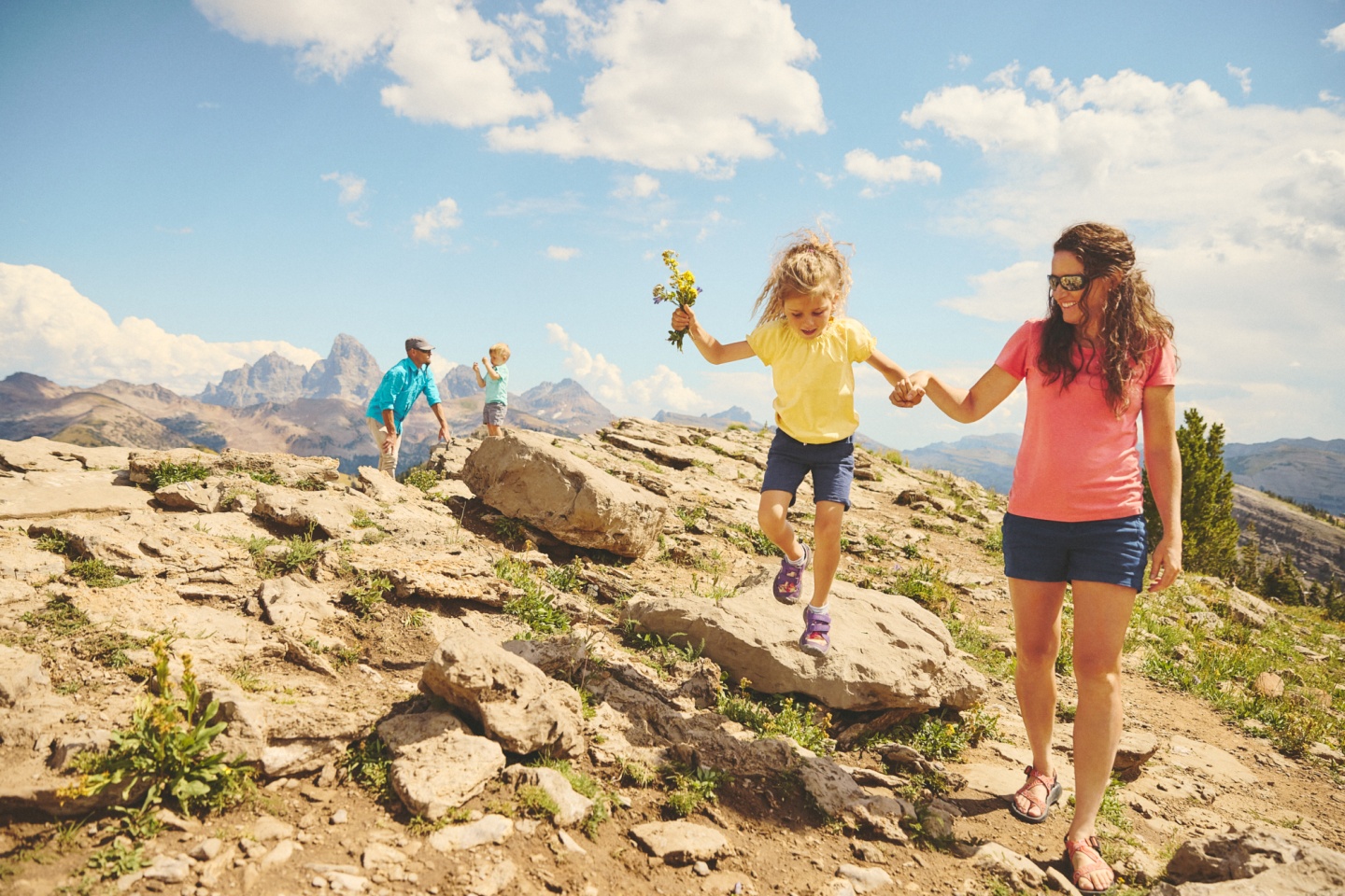 A family of four on top of a mountain