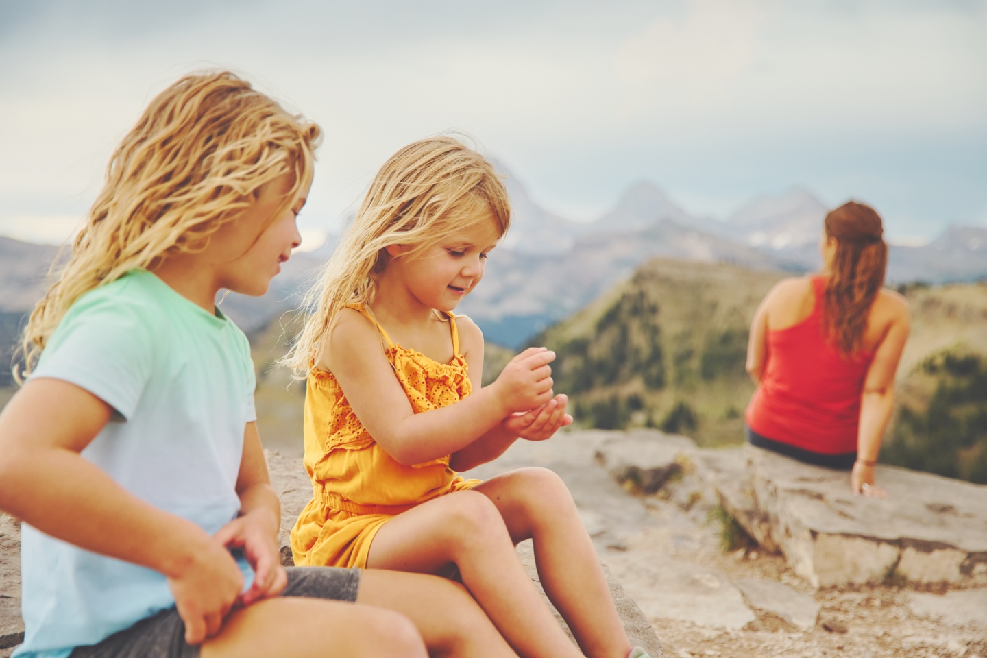Two kids chatting on top of a mountain