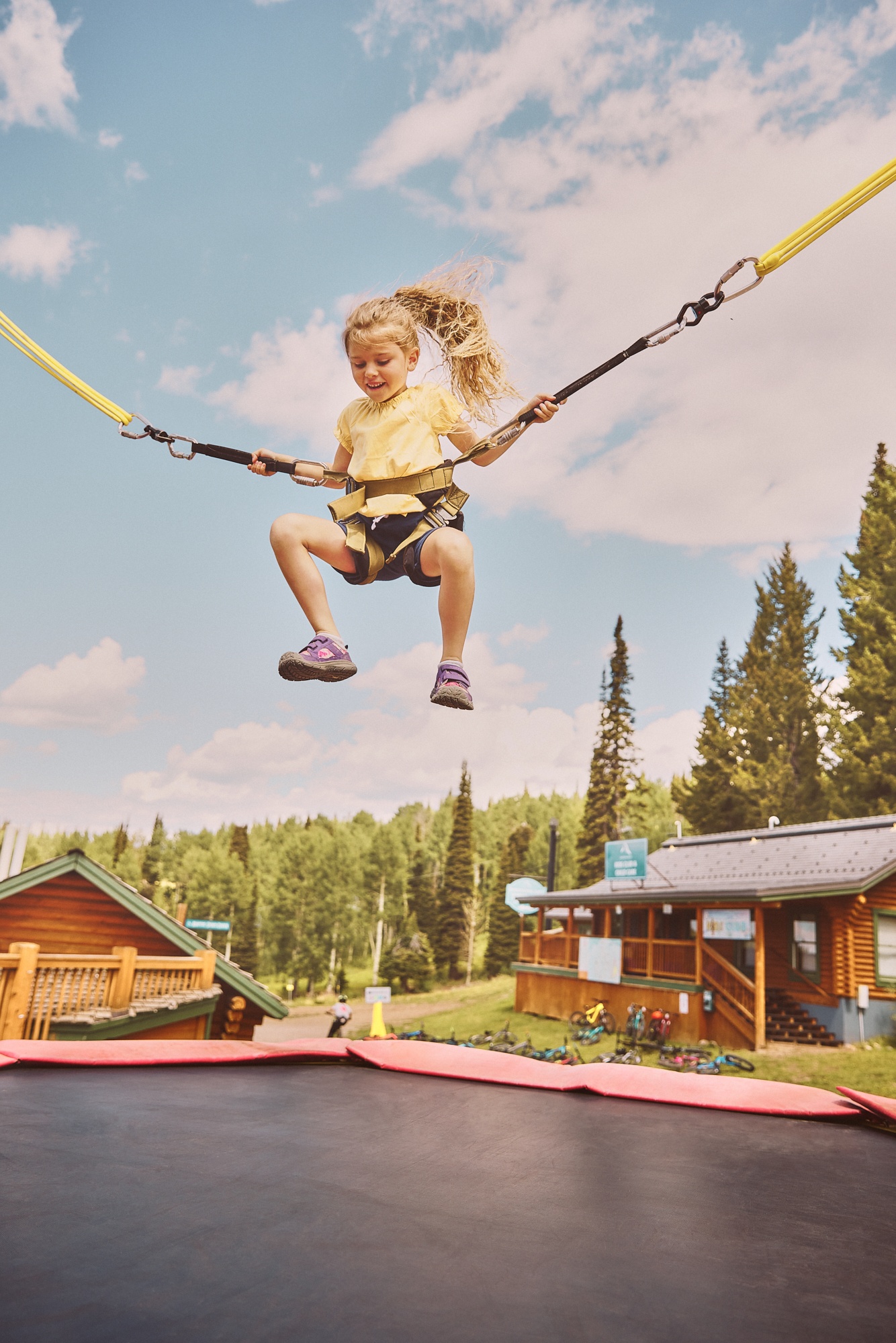 A child bounding on a bungee trampoline