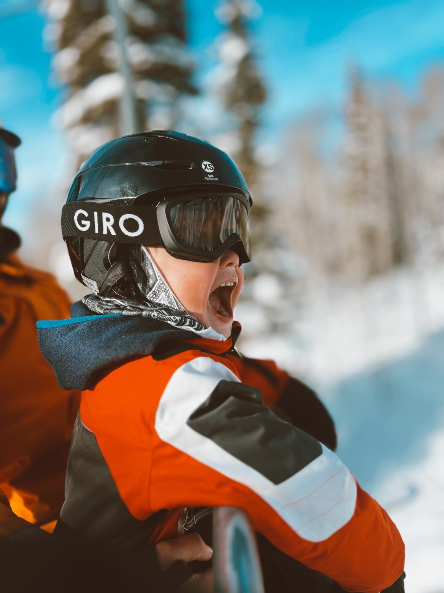 Excited child on chairlift in winter
