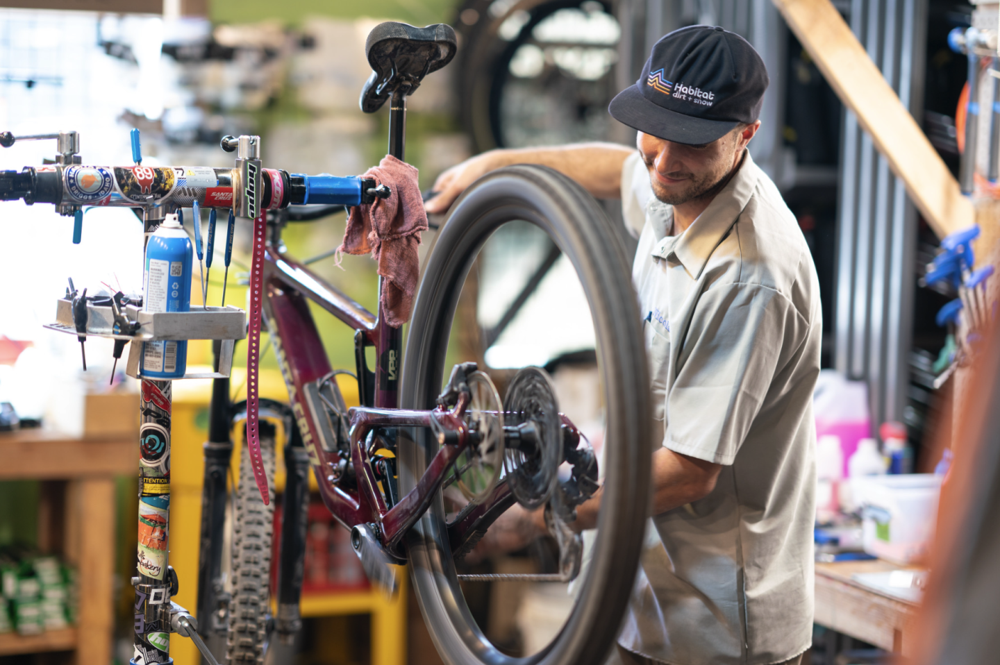Bicycle mechanic works on a bike in a workshop.