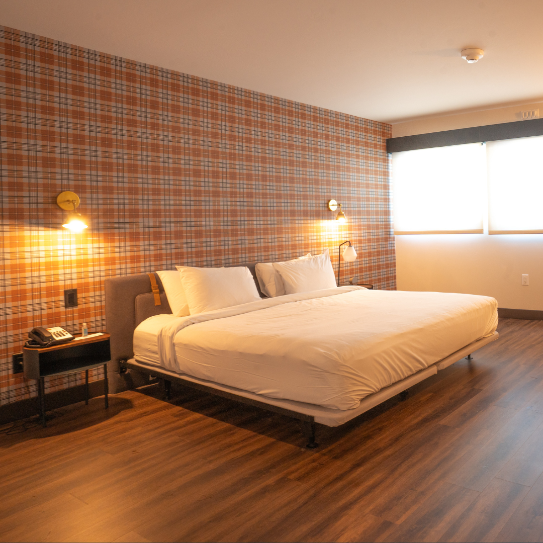 Plaid-accented bedroom with a large bed and warm lighting.