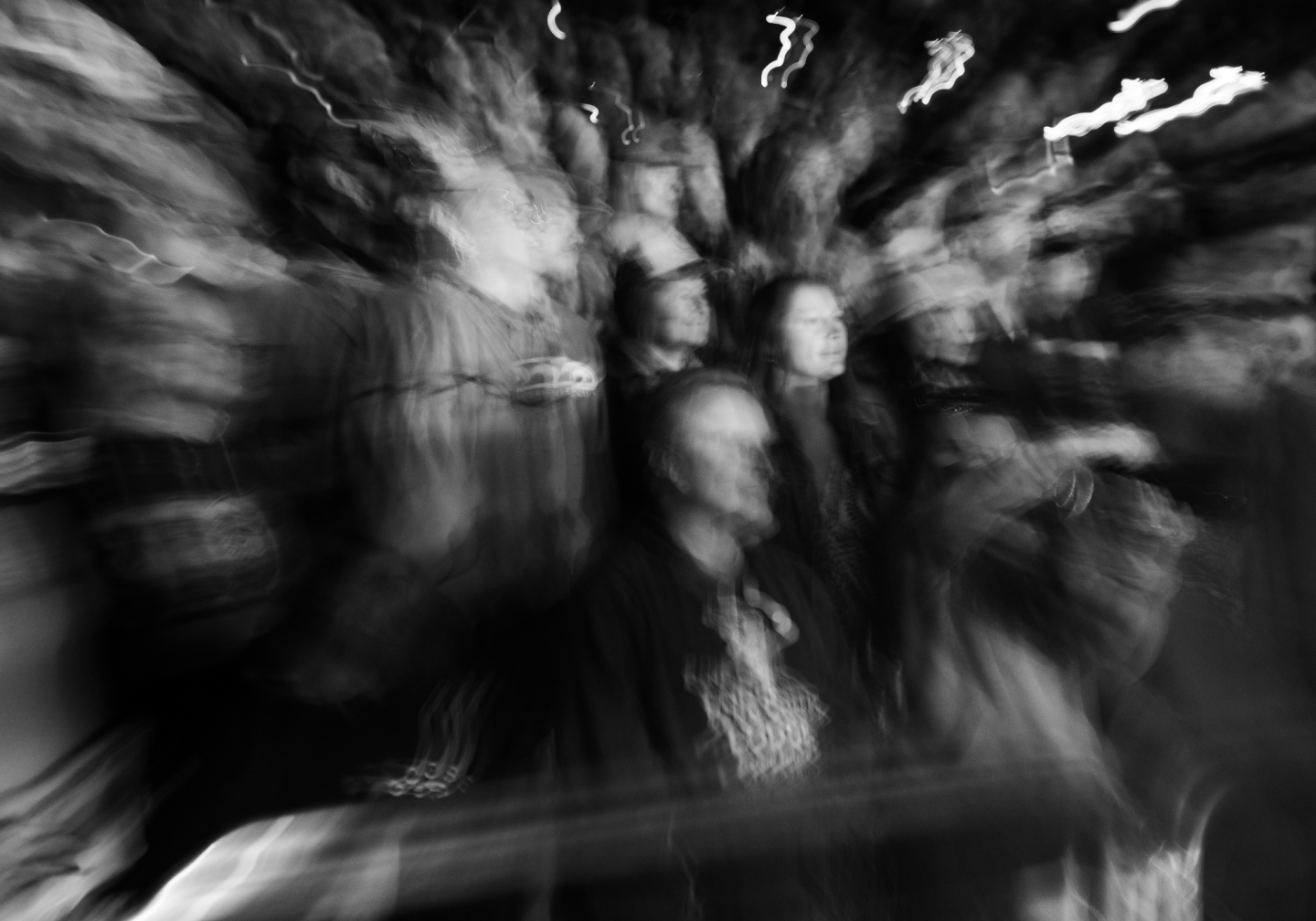 Blurry black and white photo of a crowd in motion.