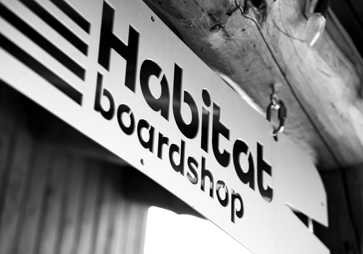 Sign reads "Habitat boardshop" in black and white.