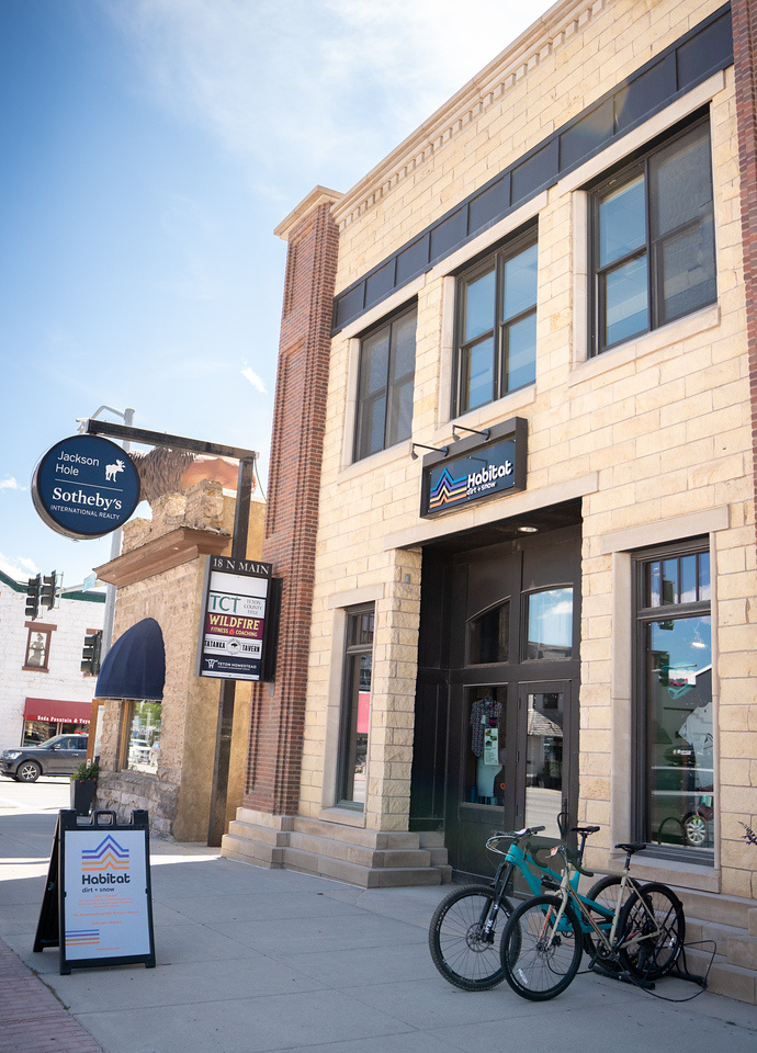 Brick building with bikes outside on a sunny day.