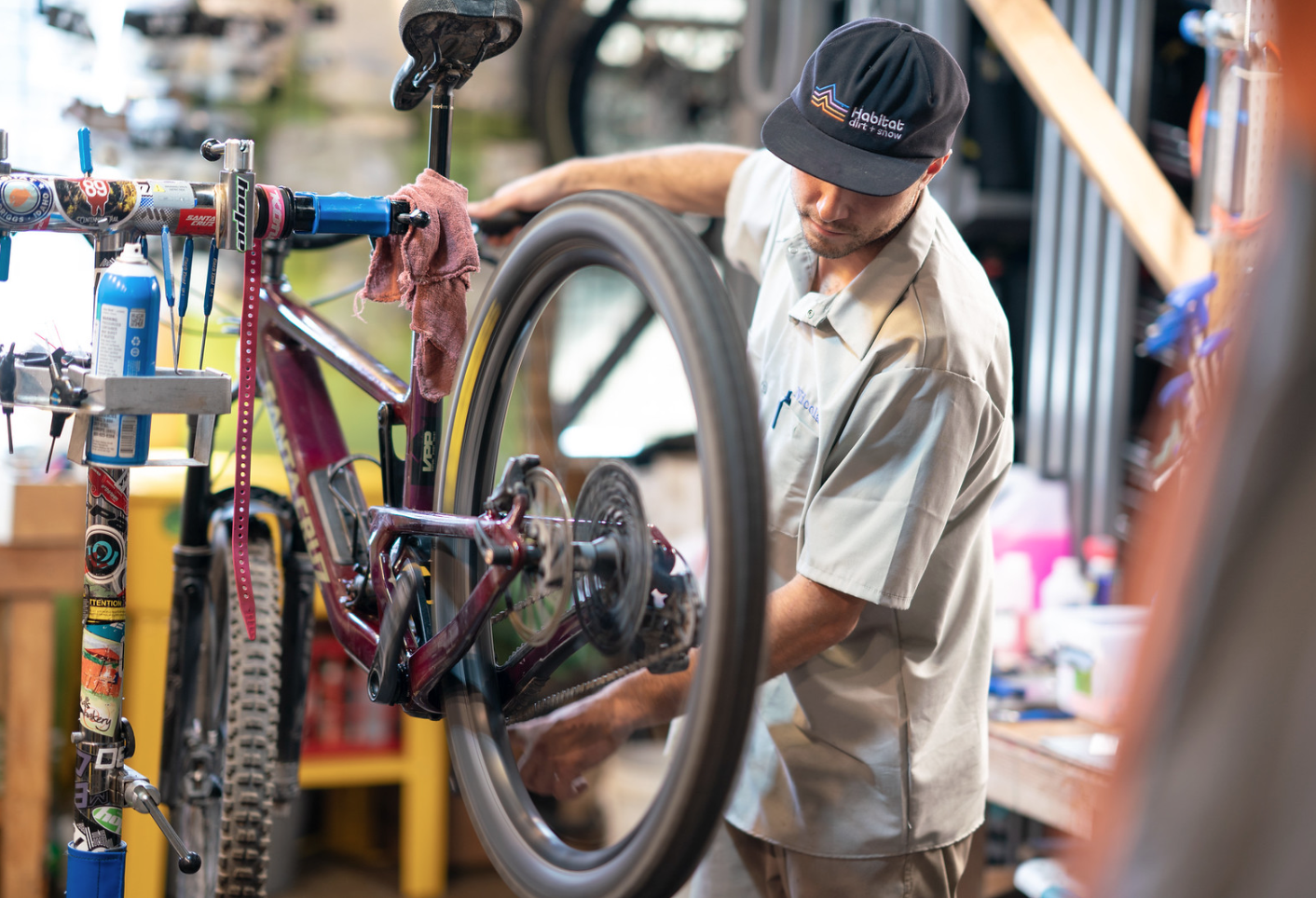 Bicycle mechanic fixing a bike wheel.