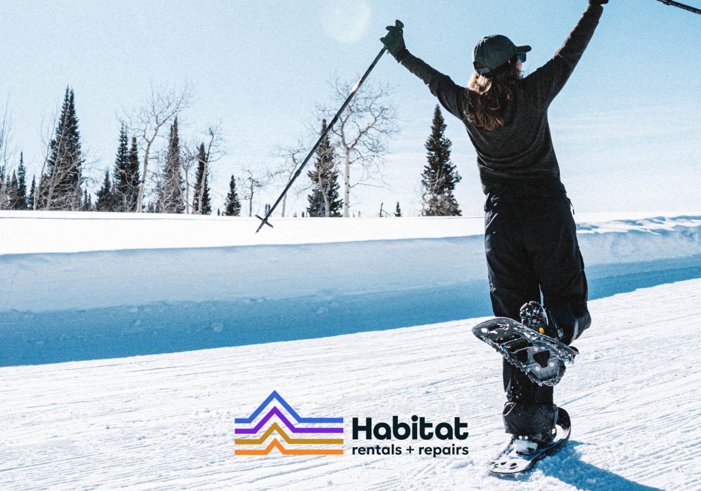 Snowboarder jumping on a snowy slope, with Habitoet logo below.